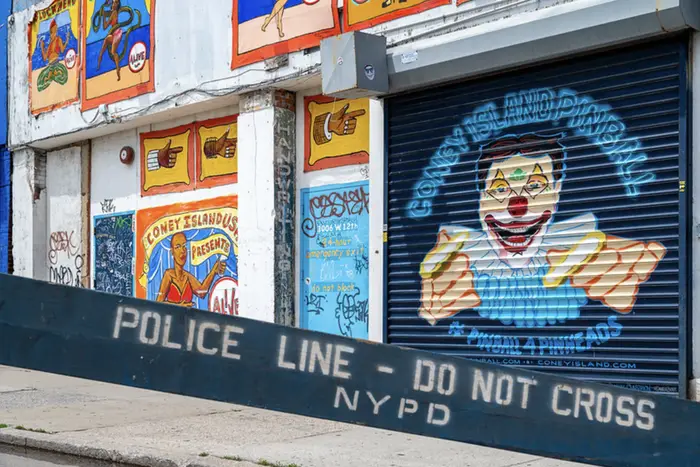 a police barricade in front of a Coney Island amusement